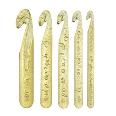 four gold colored metal objects with writing on them