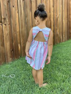 We are ready to bring in spring ! This adorable coral striped dress features an open back. Perfect for transitioning to the warmer months. Sleeveless Dress With Smocked Back For Playdate, Cute Tie Back Beach Dress, Cute Beach Dress With Tie Back, Striped Tie Back Dress For The Beach, Cute Smocked Back Dress For Day Out, Striped Tie-back Dress For Vacation, Cute Tie Back Dress For Day Out, Cute Dresses With Smocked Back For Day Out, Cute Tie-back Dress For Day Out