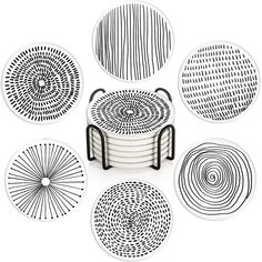 six black and white plates sitting on top of each other in front of a white background