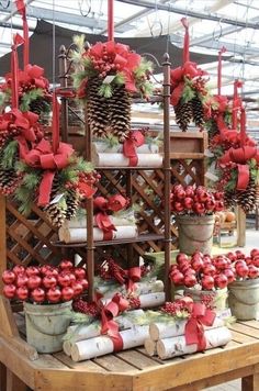 christmas wreaths and pine cones are arranged on a table