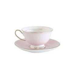 a pink cup and saucer on a white plate