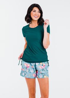 Adele Swim Top Fit & Sizing Tight Fit Sleeve Length 15.8cm (Size S) Top Length 66.5cm (Size S) If you are between sizes, or in doubt, please size up. Features Short Sleeve Round Neckline Does not feature a Built-in Bra Side ruching creates a flattering cinched look UPF 50+ Sun Protection Quick Dry Care Rinse in cold water to wash off any chemicals, chlorinated water or saltwater Machine wash in cold water on gentle cycle Lay flat to dry in the shade Material 82% Nylon Cheap Bottoms With Built-in Shorts For Pool, Cheap Stretch Activewear For Swimming, Swimsuit Shorts For Women Modlily, Cheap Sporty Swim Shorts, Affordable Sporty Short-length Swimwear, Swim Dress Modest, Swim Capris, Swim Skort, Modest Swim