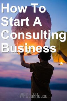 a person holding up a paper lantern with the words how to start a consulting business