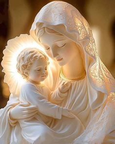 a statue of the virgin mary holding a child in her arms with sunlight streaming through