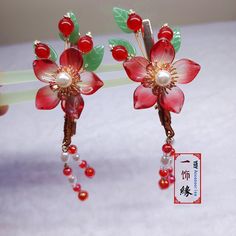 Product description Name -A Pair Of Handmade Vibrant Red Flower Hair Clip With Dangle , Chinese Hanfu Hair Clips, Asian Hanfu Bridal , Hair Accessories Material Used - Copper, Glass Beads, Acrylic Pearl Color -Red + Gold Size - 1.6  X 2.3 Inches + Tassel 2 Inches  Weight -2 OZ What is inside the shipping box - A Pair of Hair Clip Now, "LEAVE YOUR MESSAGE" service is available for free.  Simply just leave what you want to say in the gift message section when checking out or email it to me.   I will write them on the designed gift papers and send it out along with the order.  More Detail Please Visit My YouTube Channel https://www.youtube.com/channel/UCmrSifan9PoQ6xAdnu2O2tw If you like it, Please Subscribe and share my Channel. Thank you. Five Things about my hair accessories that I am prou Hanfu Hair, Copper Glass, Chinese Hanfu, Flower Hair Clip, Indigenous Culture, Gift Message, Flower Hair Clips, Hair Sticks, Red Flower