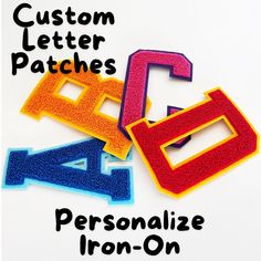 three different colored letters with the words custom letter patches