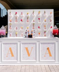 an outdoor bar with flowers and bottles on it