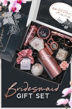 the bridesmaid gift set is in a black box with pink flowers on it