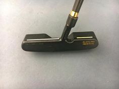 a close up of a putter on a table