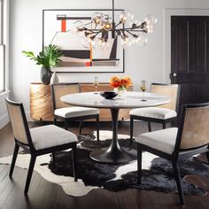 a dining room table with four chairs around it