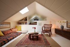 a living room filled with furniture and a rug on top of a hard wood floor