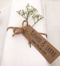 a place setting with napkins and flowers on it