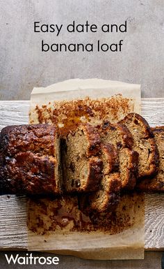 a loaf of banana bread sitting on top of a wooden table next to a knife