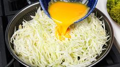 someone is pouring gravy on top of shredded cheese in a pan with broccoli