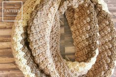 three crocheted scarves sitting on top of a wooden table