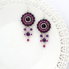 "I created this purple earring by hand, using Swarovski Rivoli (12mm) for each one, Swarovski 3mm beads, amethyst stone 6-4mm, Miyuki round seed beads, Miyuki Delica beads and Sterling Silver ear-wire Boho chic, striking and full of presence * Measurements: Earring length: 2.36\" (6cm) Pendant diameter: 0.78\" (2cm) * The earrings will come beautifully packaged for a gift. *Additional information on the matching necklace you can see here: https://www.etsy.com/listing/218652255/amethyst-crystal-n Purple Dangle Earrings, Wedding Earrings Chandelier, Boho Chandelier, Amethyst Crystal Necklace, Gold Chandelier Earrings, Gold Bridal Earrings, Earring Silver, Handmade Earrings Beaded, Purple Earrings