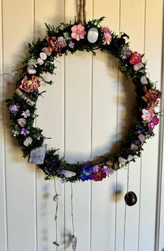 a circular wreath with flowers hanging from it