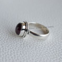 Gemstone-Garnet Shape-Oval Metal-925 Sterling Silver This One of a kind ring is adorned with beautiful Garnet Gemstone set in sterling silver. About gemstones-Garnet is intense red colour stone resembling the glistening, deep red seeds of the fruit. This red stone is associated with true friendship, devotion,loyalty, self esteem, success and passion. Garnet protects from negativity and warn off evil spirits and leads way to spiritual world.Wearing Garnet stone promotes good health and enhances b Oval Cabochon Ruby Ring In Sterling Silver, Silver Ruby Ring With Oval Cabochon, Handmade Oval Cabochon Ruby Ring For Anniversary, Classic Oval Ruby Ring Stamped 925, Spiritual World, Red Stone Ring, Colour Stone, Promise Ring Gift, Jewelry Words