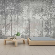 an empty room with two tables and a wallpapered mural behind it that has trees in the background