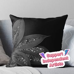 a black and white pillow with the words support independent artists on it