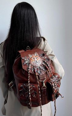 Fox womens leather backpack is my author's manual work! Materials: genuine brown leather, metal hardware, acrylic paints Sizes: 12 inches (width), 14 inches (height), 8 inches (depth). There is a beautiful decoration with manual volumetric fox embossing, manual acrylic painting, hand-painted leather feathers, leather laces and beads on the front side of this boho backpack. The pockets are also decorated with hand-painted leather feathers. The leather backpack purse for women has one handle, two Bohemian Style Leather Backpack For Everyday Use, Luxury Leather Backpack With Leather Backing For On-the-go, Bohemian Leather Backpack For Daily Use, Leather Backpack With Pockets For On-the-go, Leather Backpacks For Women, Brown Bohemian Leather Backpack, Womens Leather Backpack, Fox Gifts, Leather Feathers