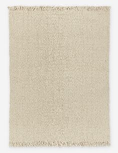 a beige rug with fringes on top