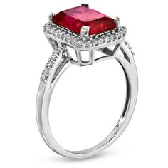 Regal and radiant, this exquisite fashion ring was designed to captivate the July-born birthday girl. Crafted in fine sterling silver, the eye is drawn to the mesmerizing 10.0 x 8.0mm emerald-cut, lab-created red ruby center stone. A frame of shimmering lab-created white sapphires surrounds the gemstone and lines the polished shank. Buffed to a brilliant shine, this ring is destined to become a treasured favorite. Custom made to fit her ring size. Sterling silver rings cannot be resized after purchase. Formal Birthstone Ring With Halo, Halo Ruby Jewelry, Formal Halo Birthstone Ring, Radiant Cut Halo Ring Fine Jewelry, Anniversary White Gold Ruby Ring With Radiant Cut, Elegant Radiant Cut Ruby Ring For Formal Occasions, Halo Ring As Gift, Fine Jewelry Halo Ring Gift, Radiant Cut Halo Setting Jewelry For Gift