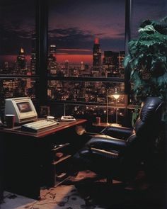 an office with a view of the city at night