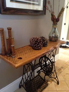 an old sewing machine with pine cones on top