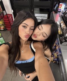 two young women hugging each other in a store