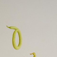 two bananas flying through the air with one banana in the foreground and another on the ground