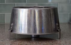 a metal pot sitting on top of a counter