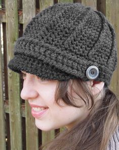 a woman wearing a crochet newsboy hat with a button