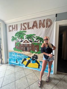 a woman standing in front of a wall with a sign on it that says chi island