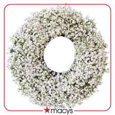 a wreath with white flowers is shown against a white background