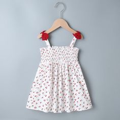 New Born Girl Cherry Print Strap Dress - PrettyKid Cute Cotton Suspender Dress With Spaghetti Straps, White Cotton Suspender Dress For Spring, White Cotton Suspender Dress For The Beach, White Cotton Suspender Dress For Beach, White Sleeveless Cotton Suspender Dress, Playful Sleeveless Dress With Tie Straps, White Cotton Suspender Dress With Spaghetti Straps, Cute White Suspender Dress For Summer, White Cute Suspender Dress For Summer