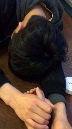 a woman laying on the floor with her head in her hands while she is sleeping