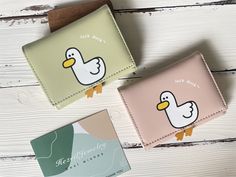 two wallets with ducks on them sitting next to each other