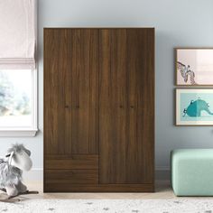 a child's bedroom with a teddy bear and wooden wardrobes in the corner