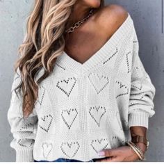 Oversized V-Neck Hearts Knit Pattern Sweater. 3/4 Length Sleeve. Please Note: Model In Photo Is Size Small, Wearing A Large. Trendy Long Sleeve Pointelle Knit V-neck Sweater, Oversized Heart Print Sweater For Fall, Oversized Heart-shaped Sweater For Winter, White Heart-shaped Sweater For Spring, Trendy Oversized White V-neck Sweater, Cozy Heart-shaped Sweater, Fall Heart-shaped Sweater, Long Sleeve Knit Tops With Heart Print, Knit Long Sleeve Tops With Heart Print