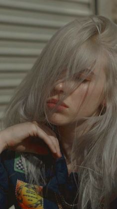 a woman with long grey hair is posing for the camera