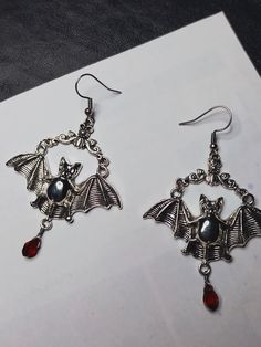 Elvira's Bat Hoop Earrings. Bat Earrings, Silver Earrings, Vintage Bat Jewelry, -Thank you for choosing us. Length - 5 cm. Width - 5 cm. CONDITION: New When placing an order, please write your phone number, this is required by the transport company. Thank you.  ❤︎ Click here to visit my store ❤︎ Dark Beauty:  https://www.etsy.com/shop/DarkBeauty8?ref=seller-platform-mcnav Bat Hoop Earrings, Gothic Pierced Hoop Earrings As Gift, Gothic Hoop Earrings As A Gift, Gothic Dangle Hoop Earrings, Gothic Hoop Earrings For Gift, Gothic Hoop Earrings For Pierced Ears, Silver Gothic Hoop Earrings As Gift, Gothic Hoop Single Earring, Novelty Metal Earrings With Ear Wire