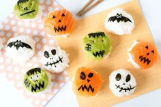 halloween cupcakes decorated with white frosting and sprinkles on a table