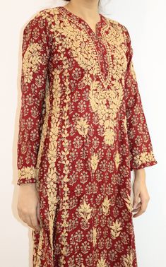 Introducing our beautiful Navya A-line Kurta. Crafted with precision, this kurta features two kali panels that create a graceful silhouette. The entire ensemble is adorned with stunning contrast gold Chikankari embroidery, adding a touch of opulence to every detail. Designed for both sophistication and comfort, this kurta boasts an A-line shape that drapes gracefully, flattering every figure. The intricate Chikankari embroidery in gold thread showcases the artistry and craftsmanship that goes into creating this masterpiece. Embrace the richness of tradition in a contemporary form as you step out in this mesmerizing ensemble. Length - 48 inches Sizes -  S - fits bust 34 M - fits bust 36 L - fits bust 38 XL - fits bust 40 0X - fits bust 42 1X - fits bust 44 Machine wash cold. Line dry, Light Gold Salwar Kameez With Long Sleeves And Embroidery, Gold Semi-stitched Chanderi Sherwani, Designer Gold Embroidered Fabric For Eid, Gold Kurta With Intricate Embroidery Unstitched, Unstitched Gold Kurta With Intricate Embroidery, Gold Straight Kurta Set With Intricate Embroidery, Diwali Salwar Kameez With Gold Embroidery, Chanderi Salwar Kameez With Gold Embroidery, Diwali Gold Embroidery Straight Kurta Salwar Kameez