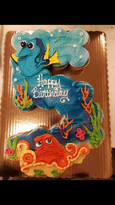 two cupcakes decorated like sea animals on top of each other