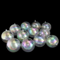 a bunch of shiny glass ornaments on a black background