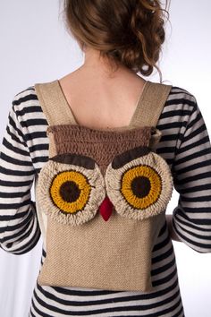 a woman wearing an owl sweater and striped shirt