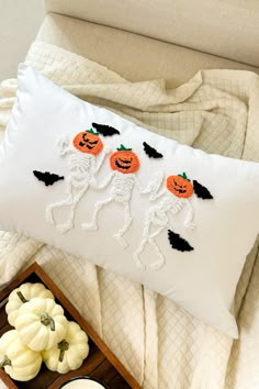 a white pillow with halloween decorations on it