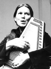 a woman holding an accordion in her hands