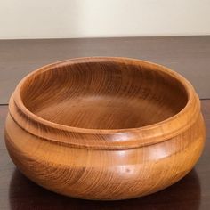 a wooden bowl sitting on top of a table